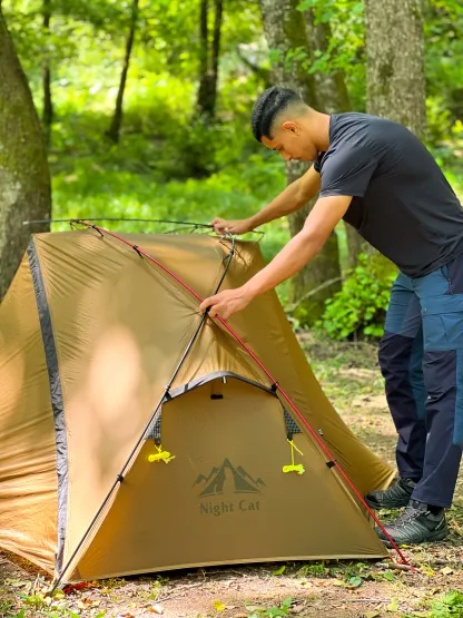 Solo camper assembling the Night Cat 1 Person Tent